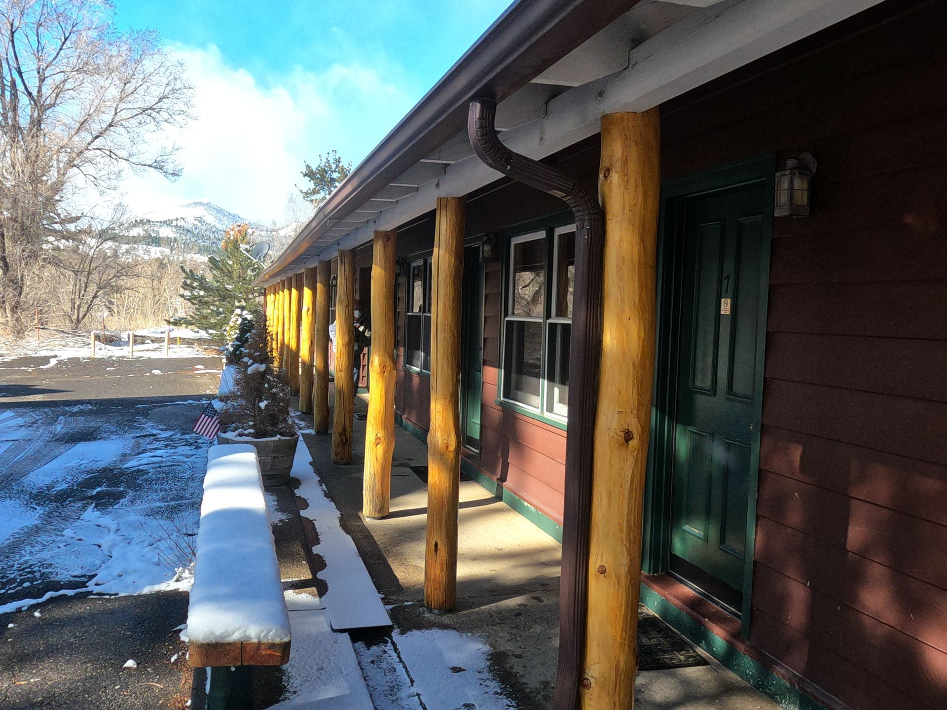 A row of wooden posts along the side of a building