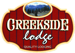 A red sign that says creekside lodge quality lodging