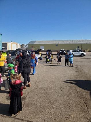 A group of people are standing in a parking lot.