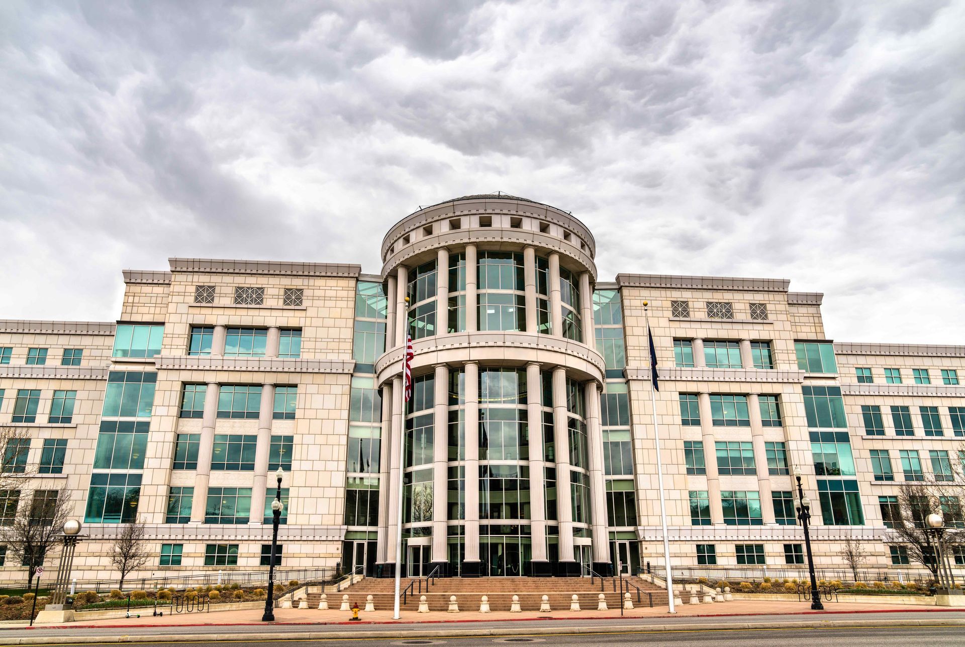A large building with a lot of windows on a cloudy day.