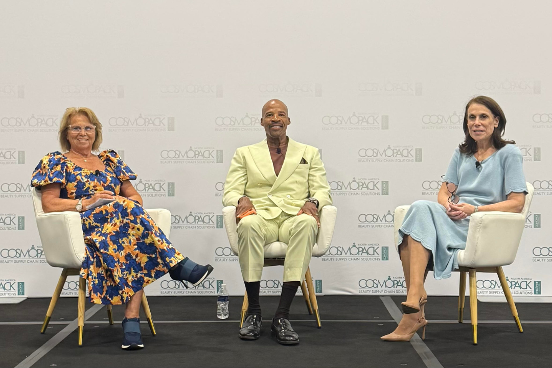 Three people sit on stage for 