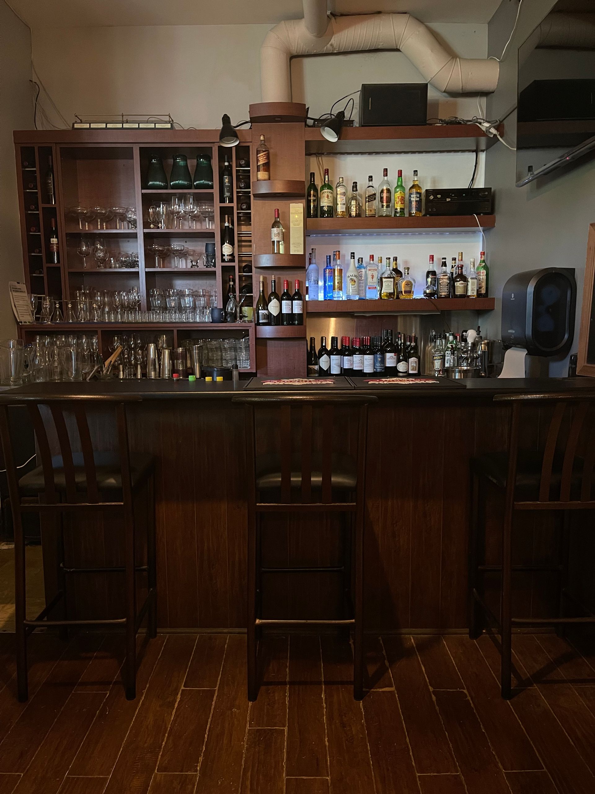 People clinking wine glasses around a table in a restaurant, soft lighting.