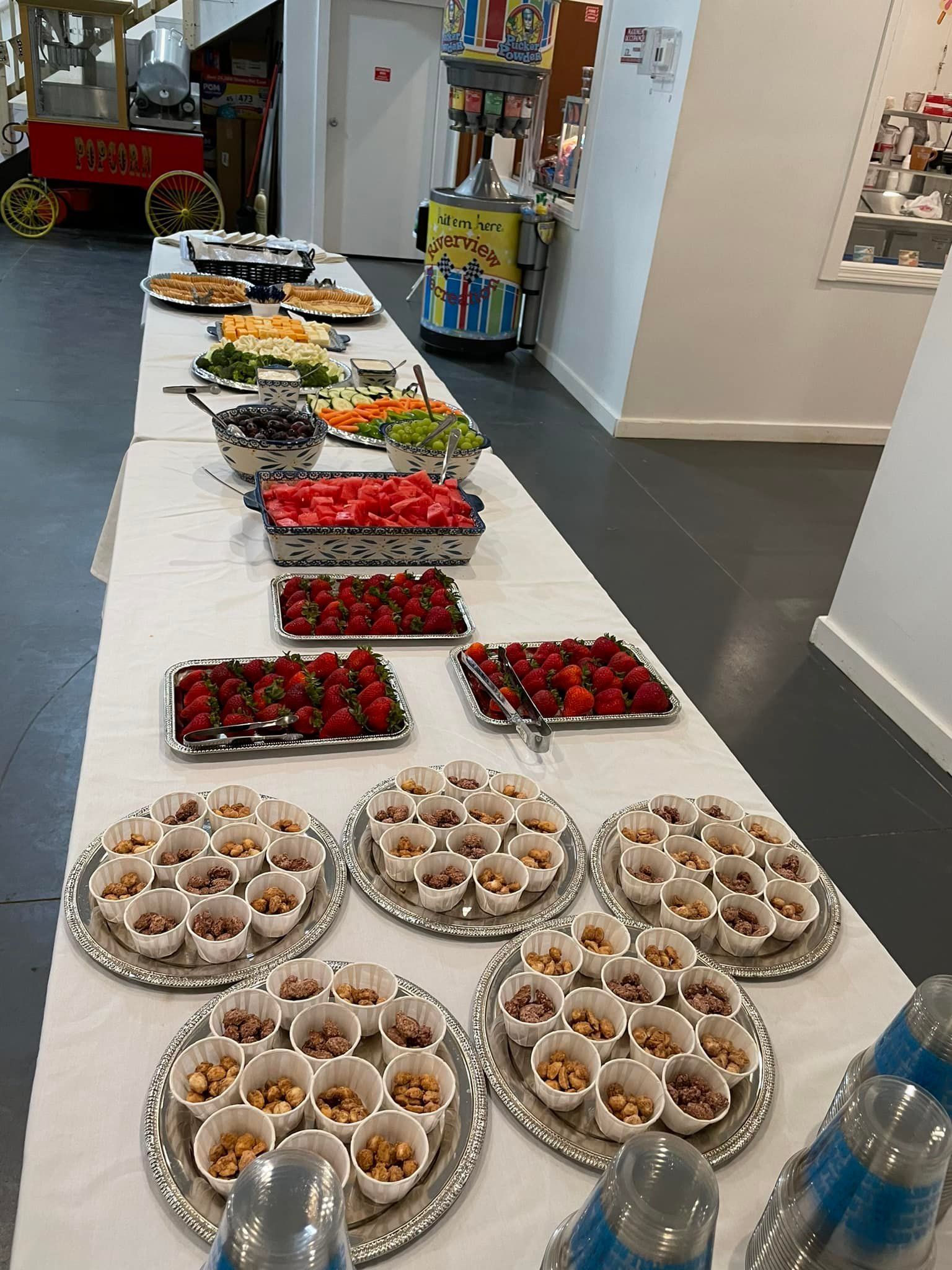 A long table with a variety of food on it.