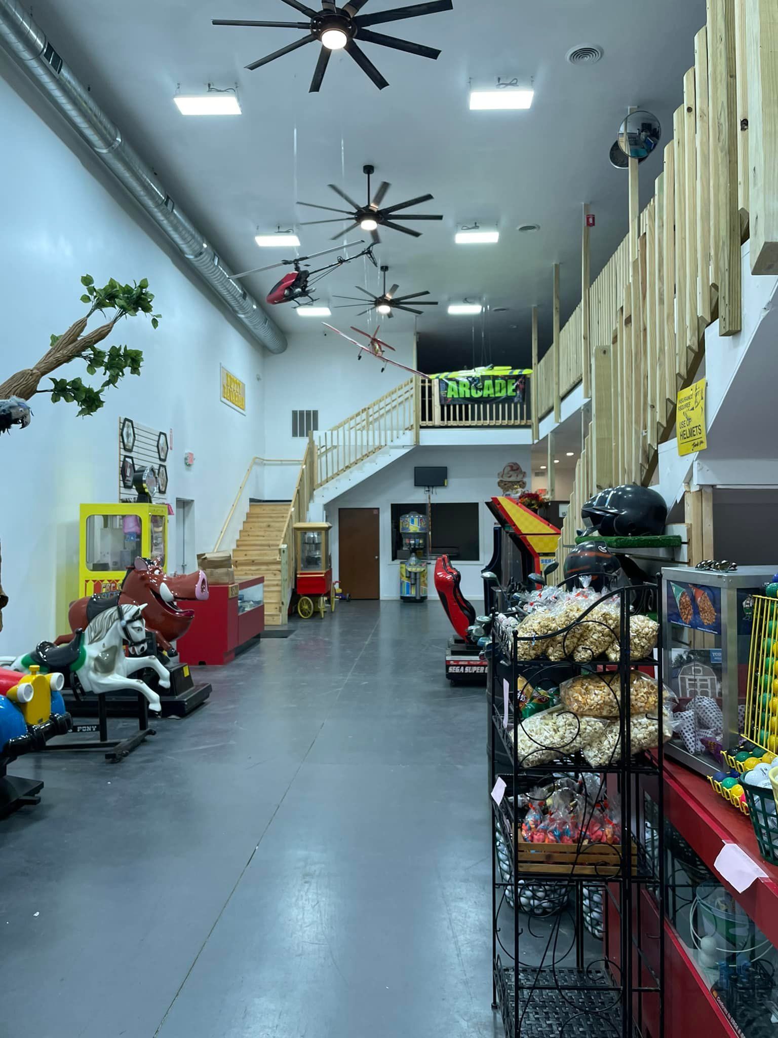 A large room with a lot of toys and a ceiling fan