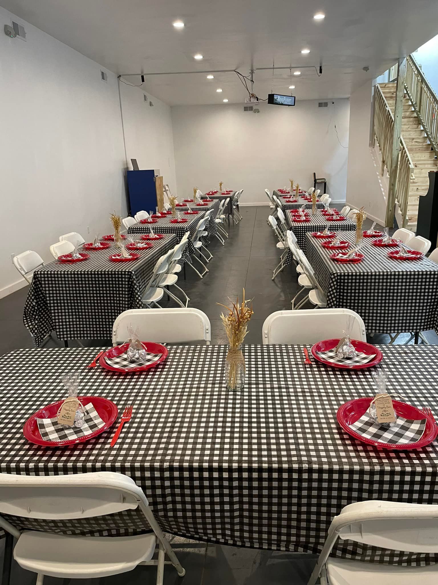 A room filled with tables and chairs set up for a party.