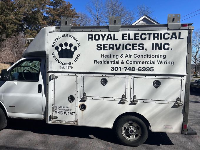 White work truck for Royal Electrical Services, Inc. Text on side: Heating, Air, and wiring. Phone: 301-748-6995.