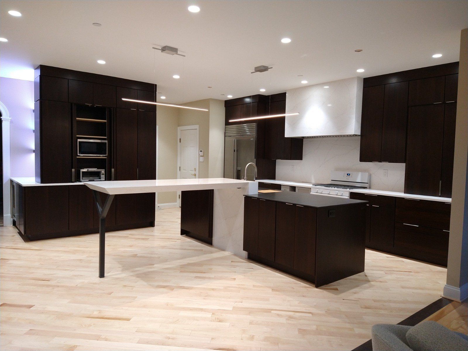 A kitchen with brown cabinets and white counter tops