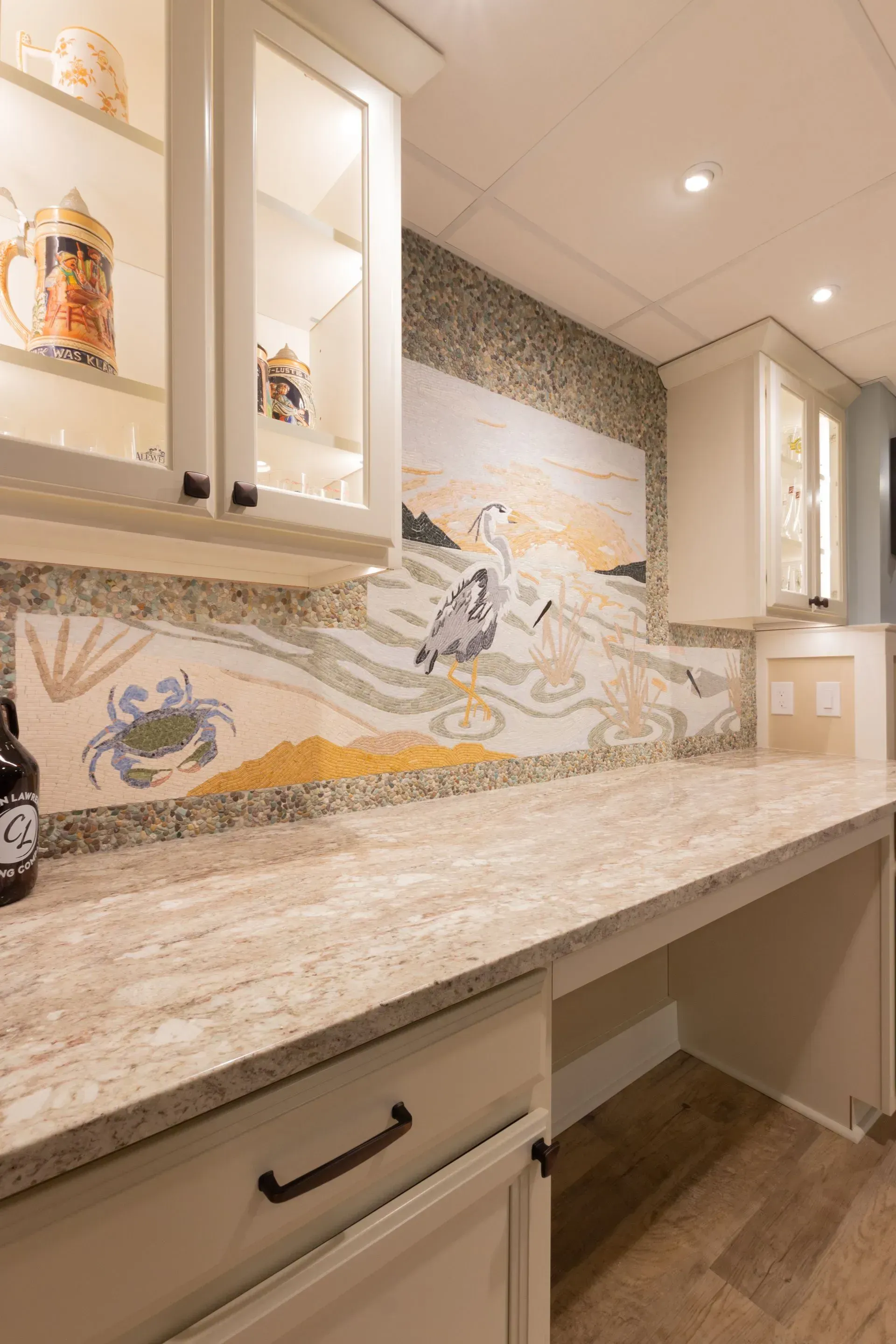 There is a painting on the wall above the counter in the kitchen.