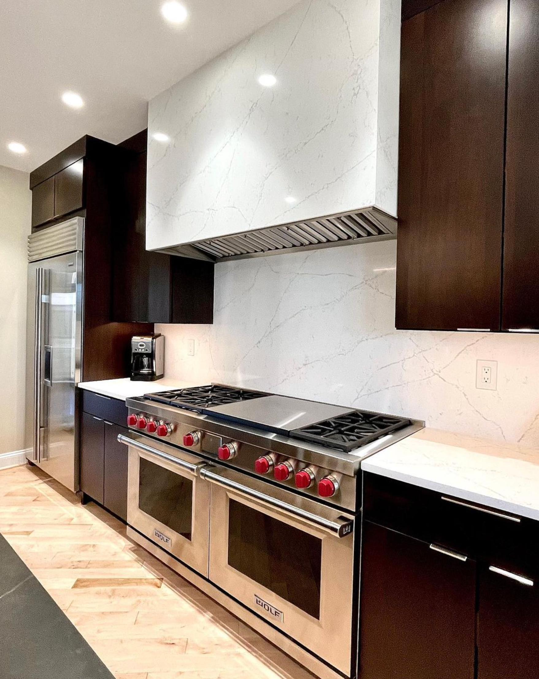 A kitchen with stainless steel appliances and wooden cabinets