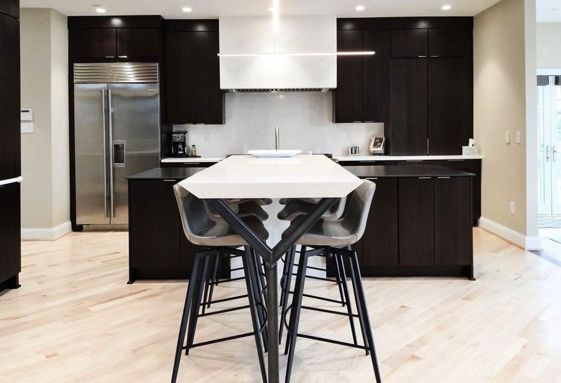 A kitchen with a table and chairs in it