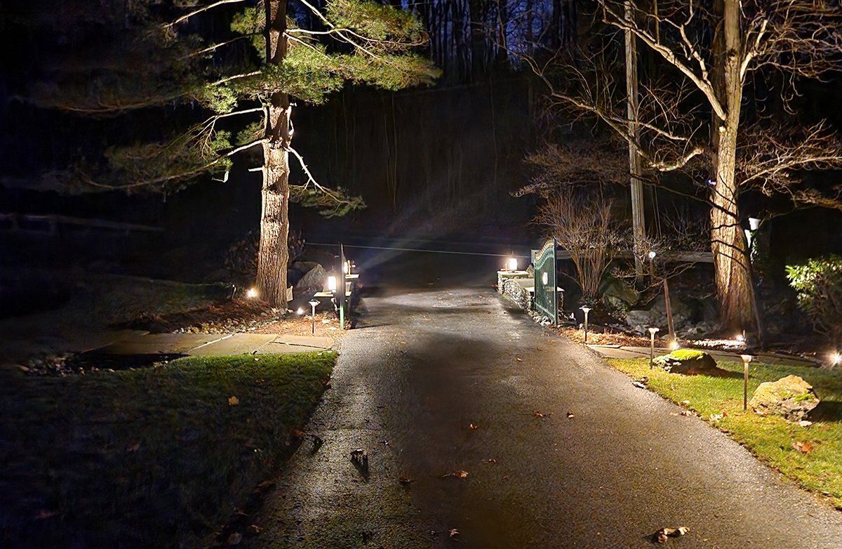 A car is driving down a road at night.