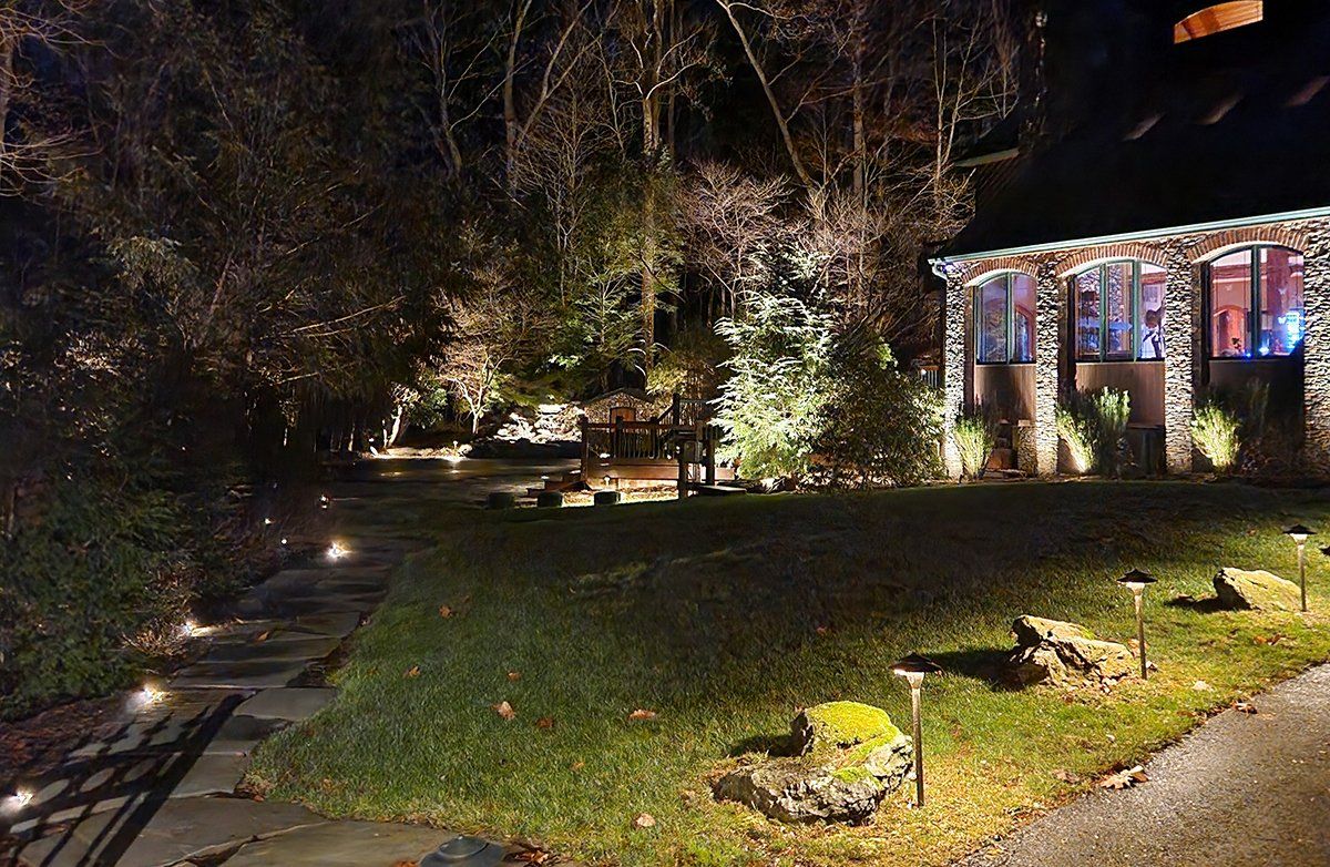 A house is lit up at night with christmas lights.