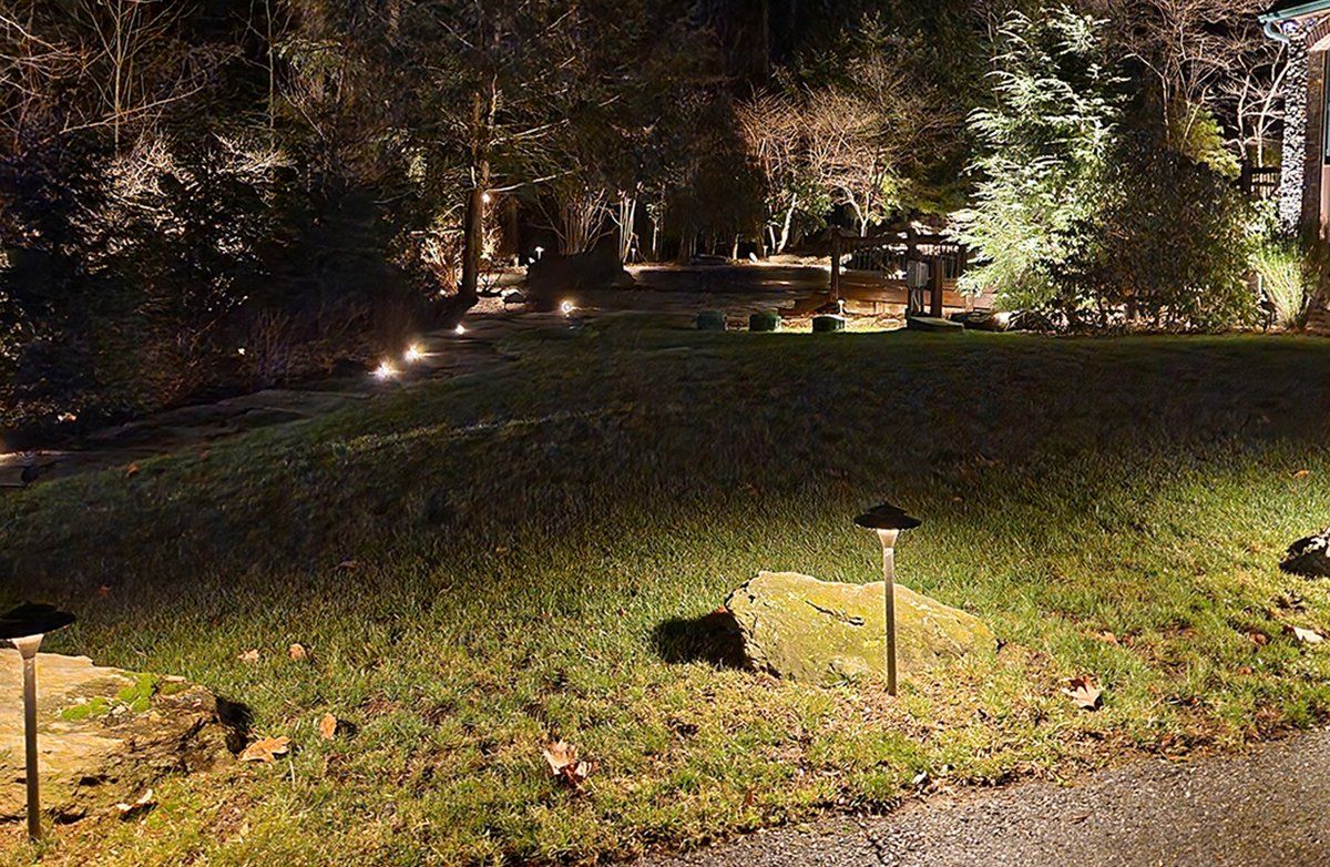 A lawn with a lot of lights on it at night.