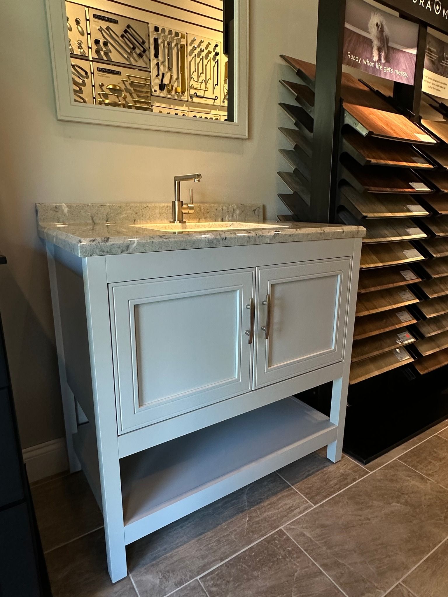 A bathroom vanity with a sink and a mirror in a store.