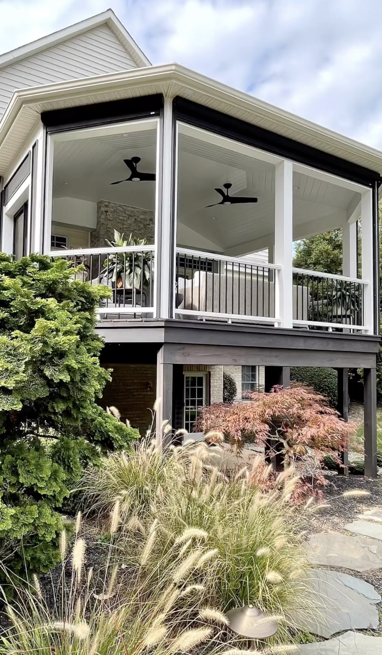A house with a large porch and a ceiling fan.