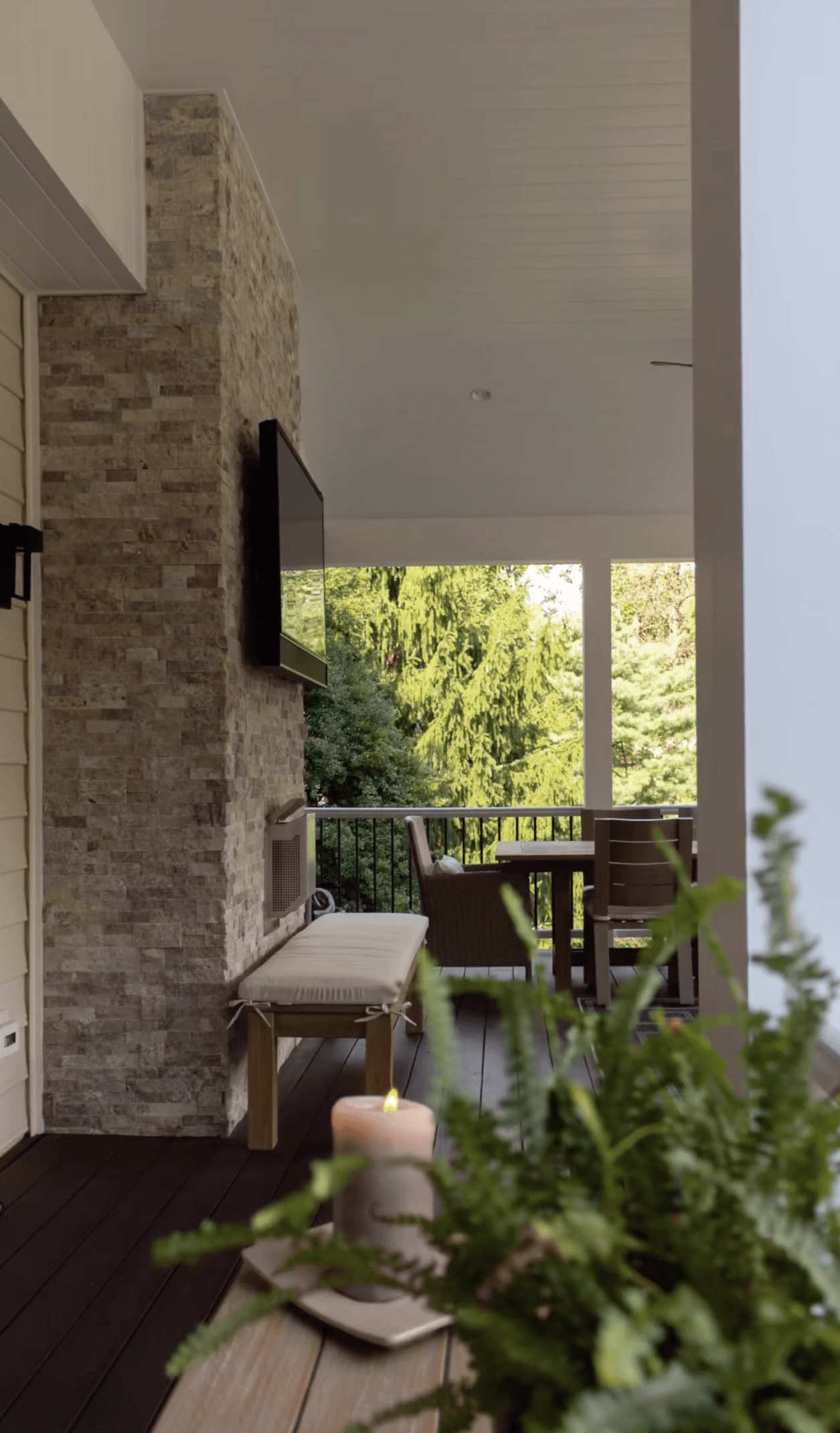 A living room with a fireplace and a candle on a table.
