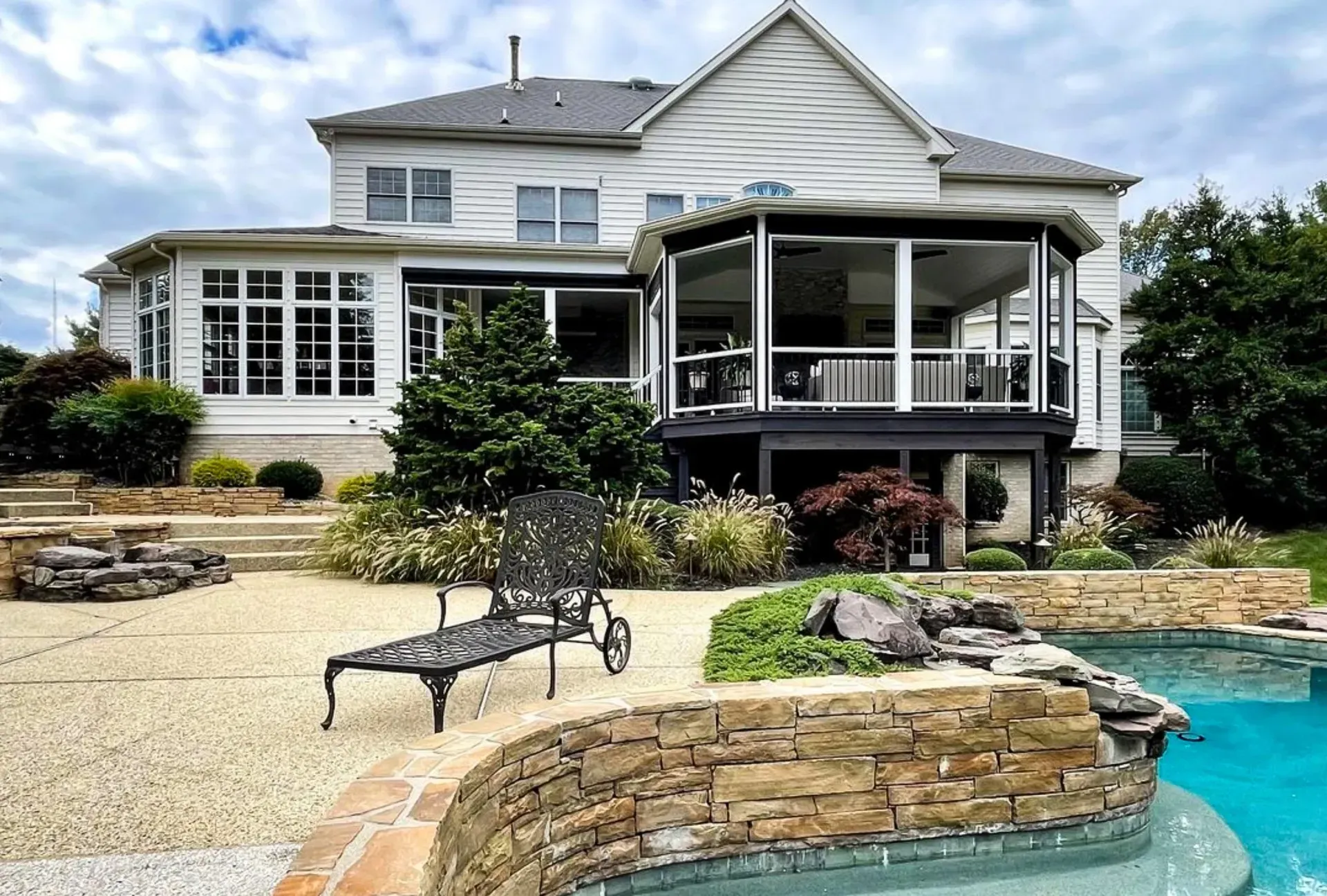 A large white house with a swimming pool in front of it