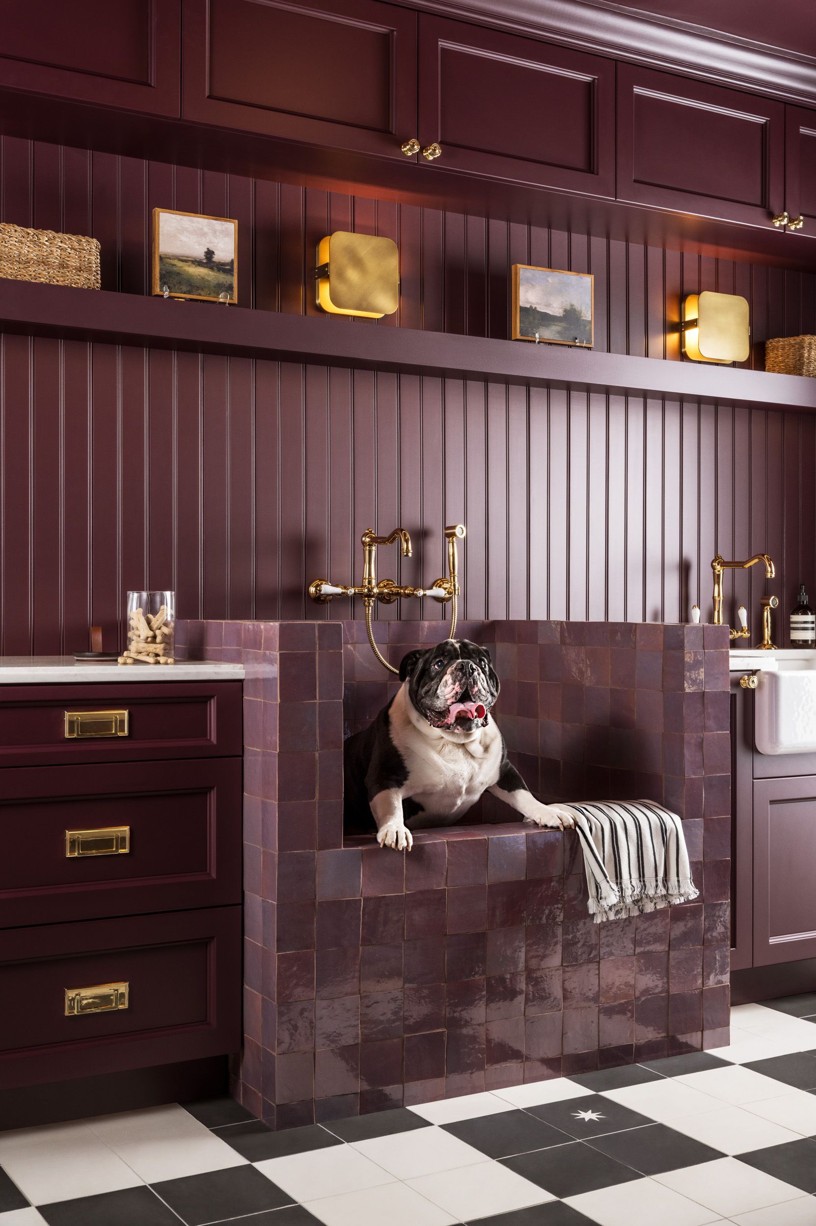 A dog is sitting in a bathtub in a bathroom.