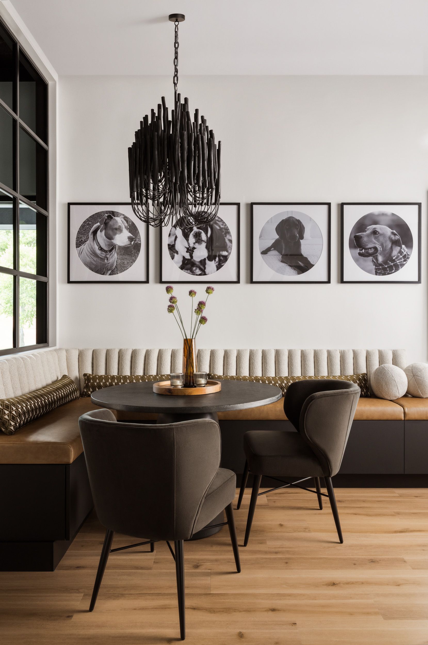 A dining room with a table and chairs and a chandelier hanging from the ceiling.