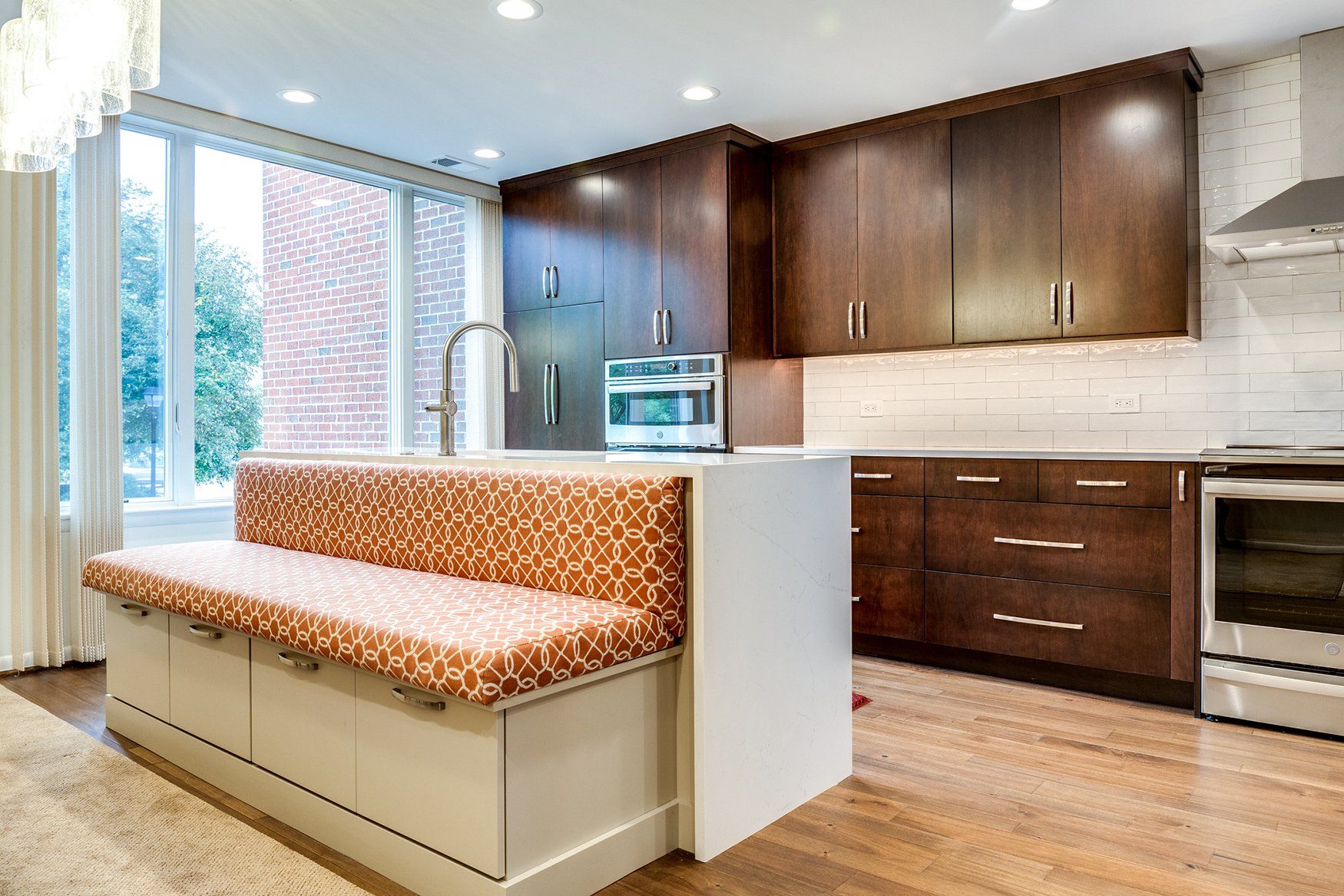 A kitchen with stainless steel appliances and wooden cabinets