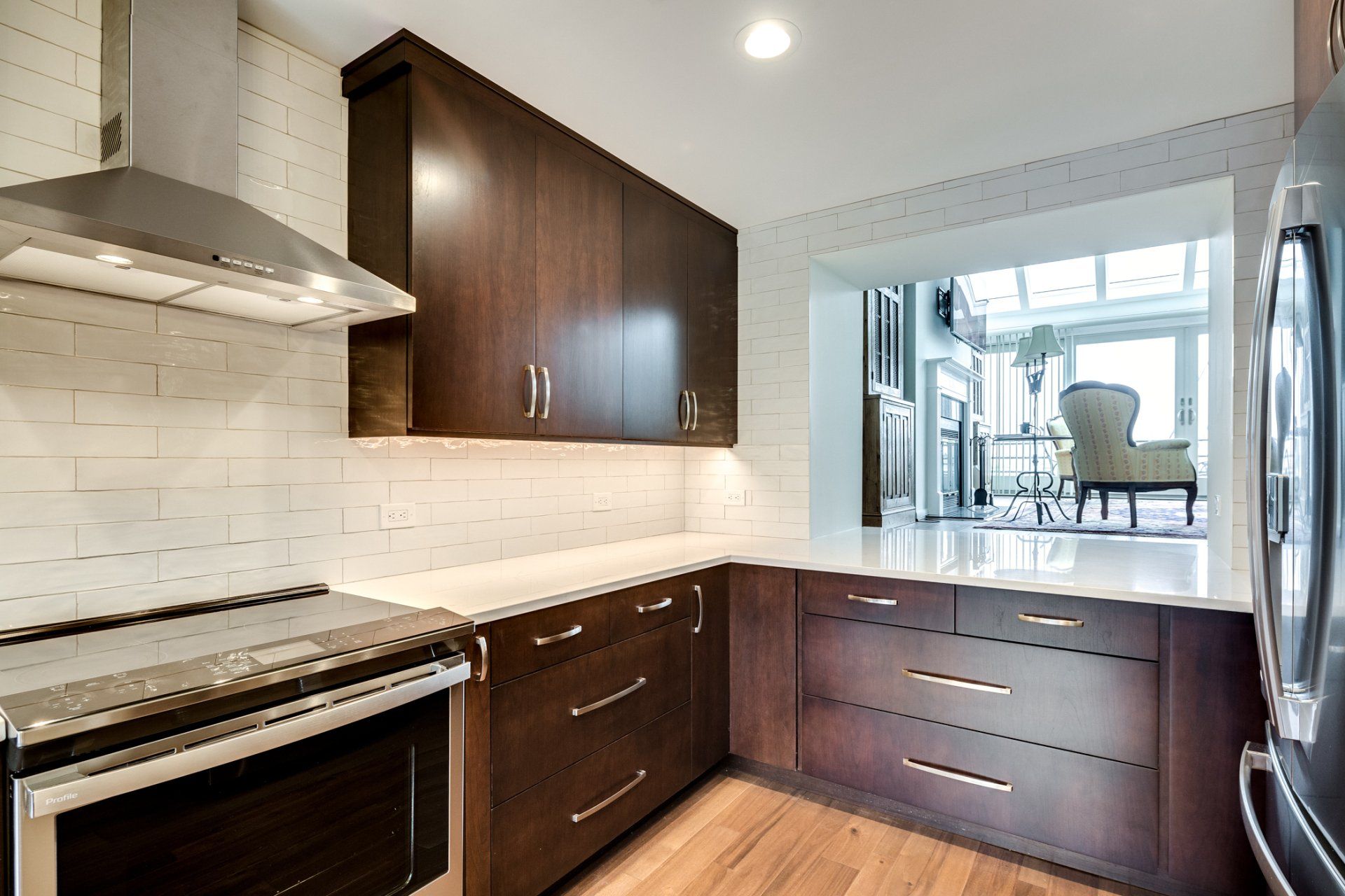 A kitchen with stainless steel appliances and wooden cabinets