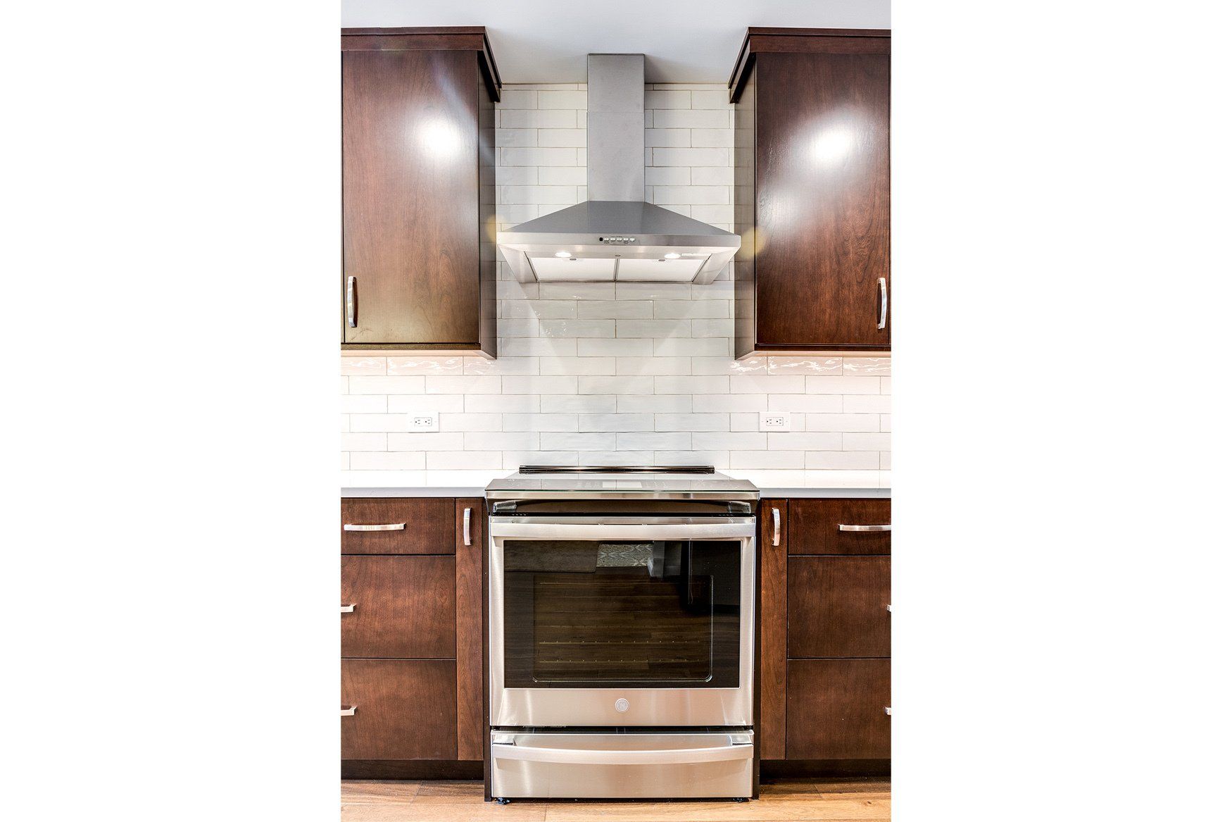 A kitchen with stainless steel appliances and wooden cabinets.