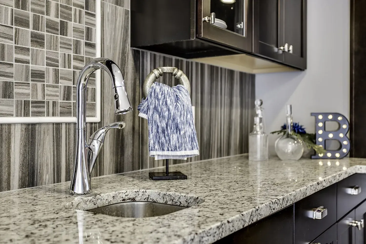 A kitchen with granite counter tops and a sink.