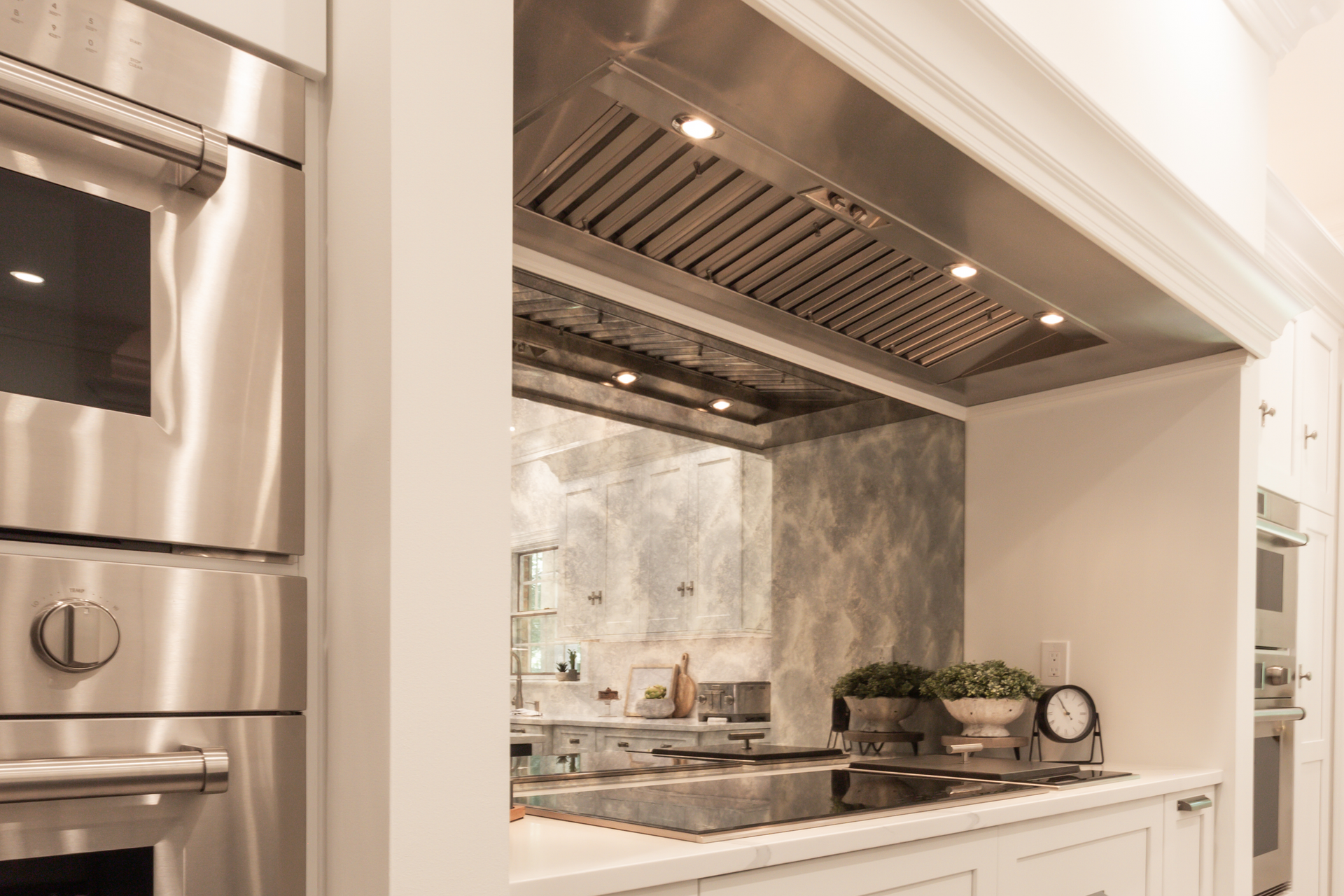 A kitchen with stainless steel appliances and a stove top oven.