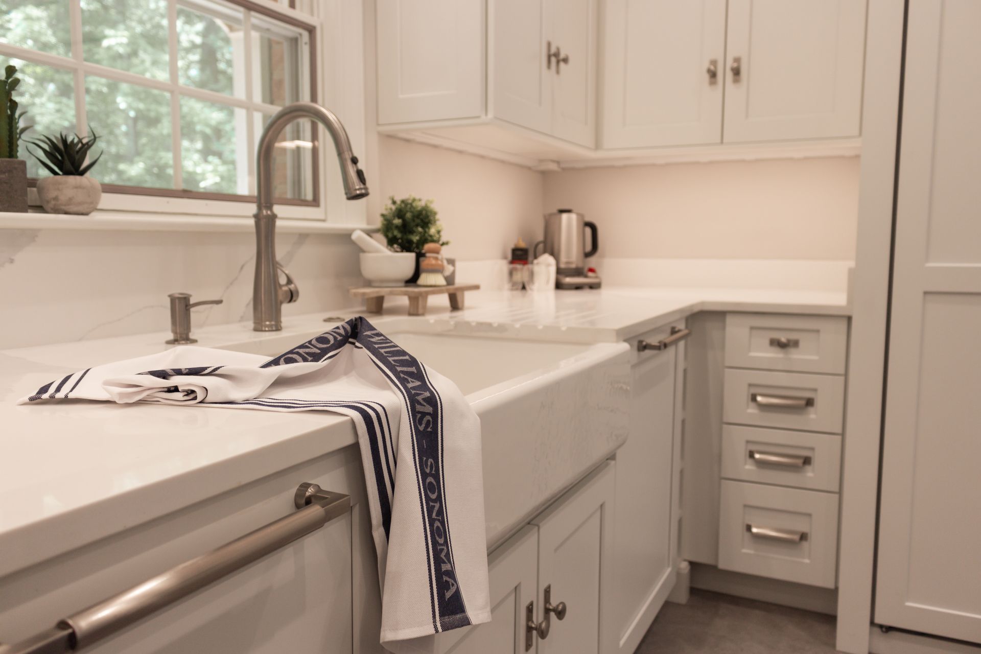 A kitchen with a sink and a towel on the counter.