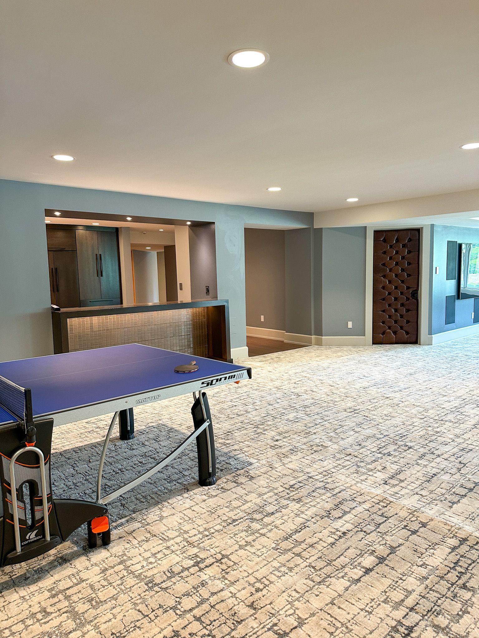 There is a ping pong table in the middle of the room.