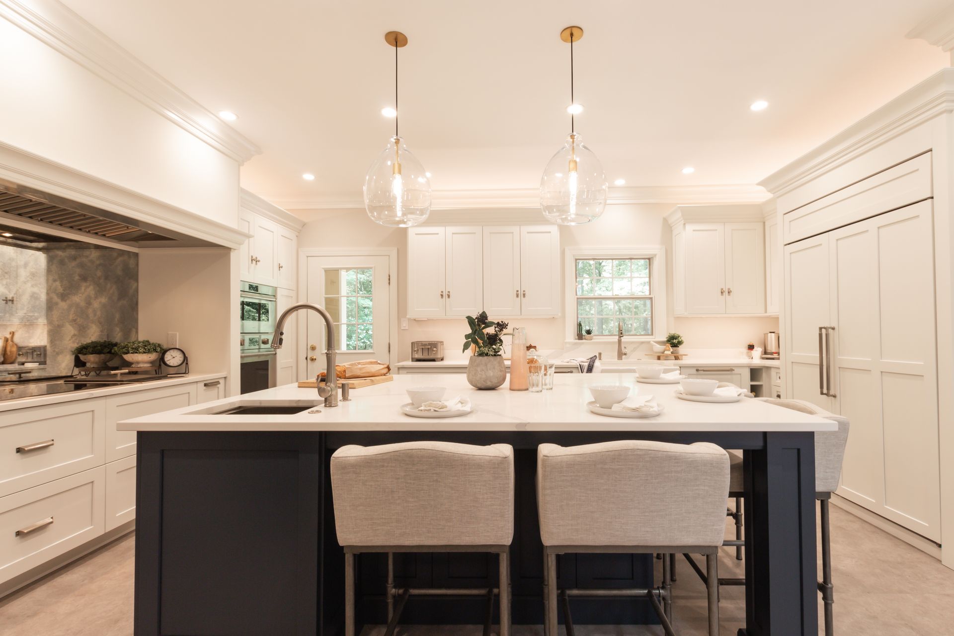 A large kitchen with a large island and stools.