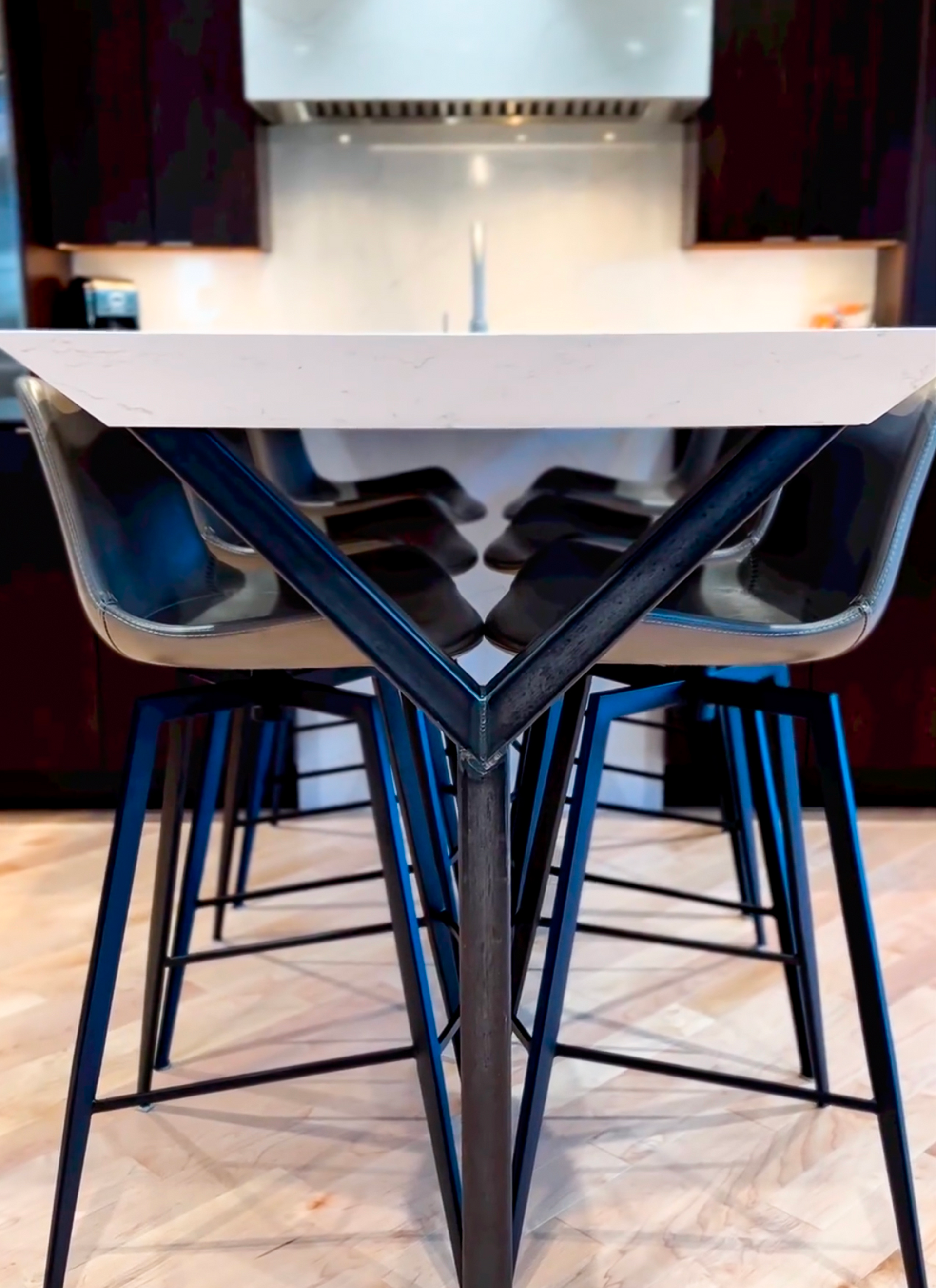 A kitchen with a table and chairs and a sink