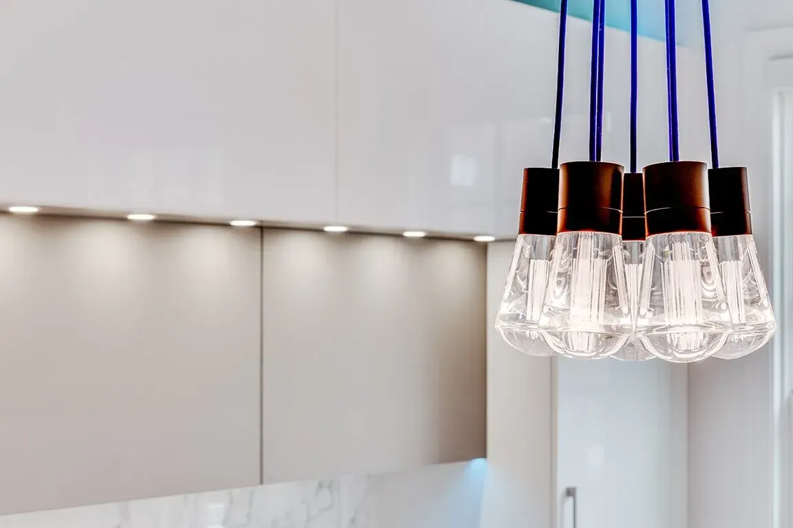 A bunch of light bulbs hanging from the ceiling in a kitchen.