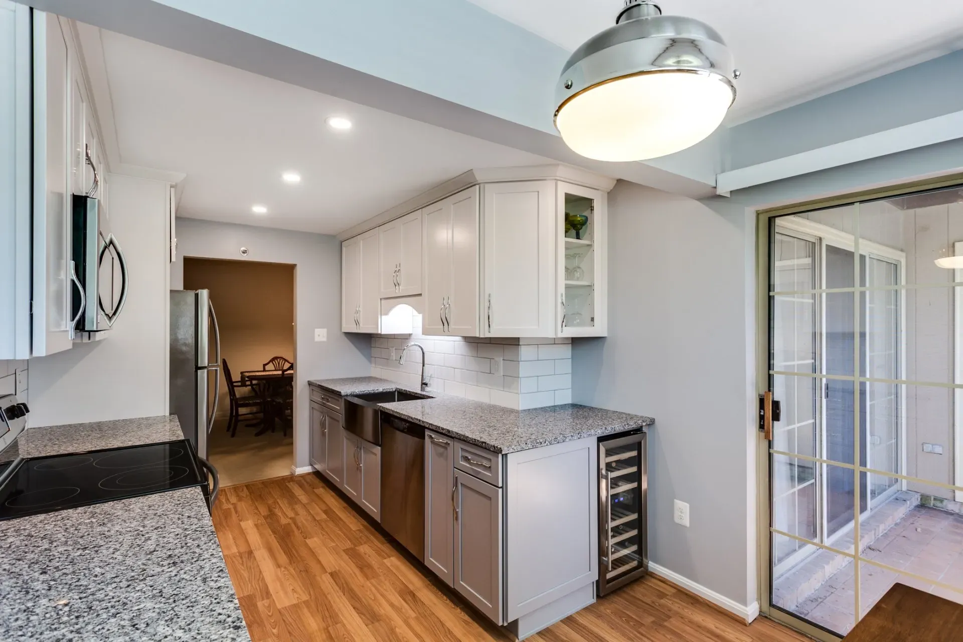 A kitchen with granite counter tops and stainless steel appliances.