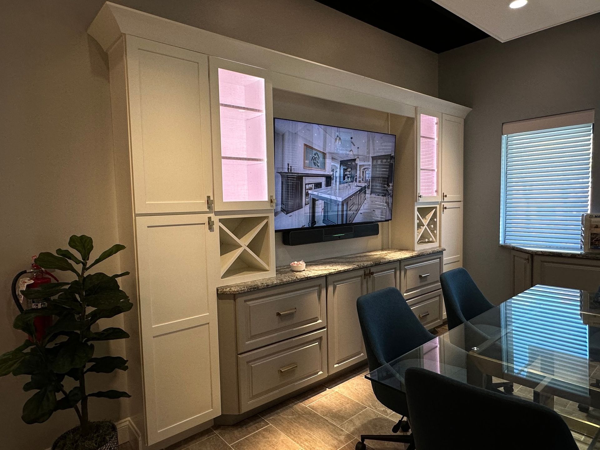 A conference room with a large flat screen tv on the wall.