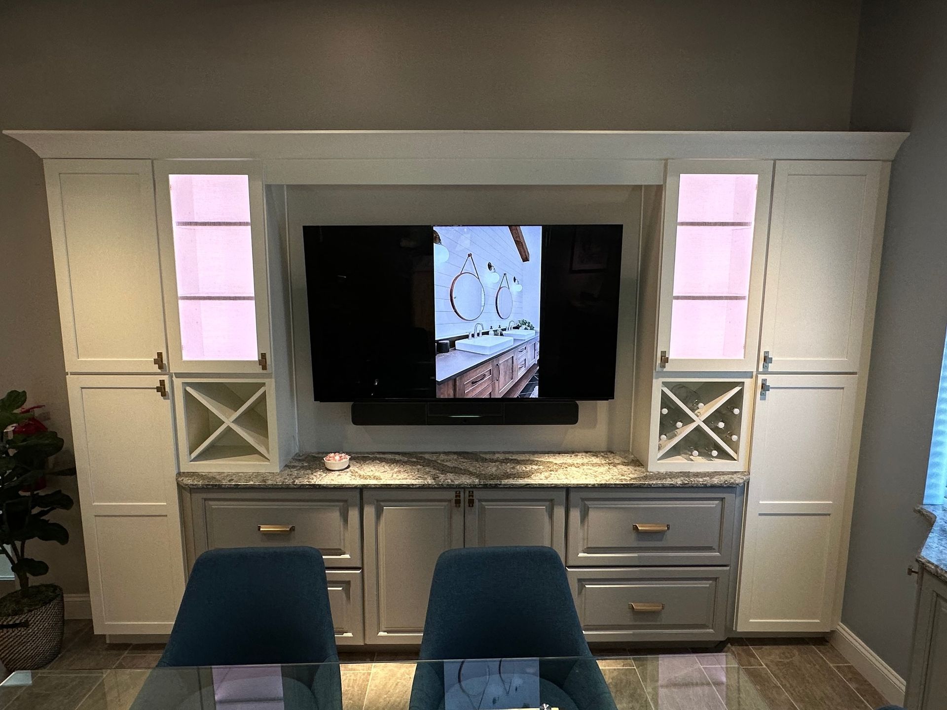 A living room with a large flat screen tv mounted to the wall.
