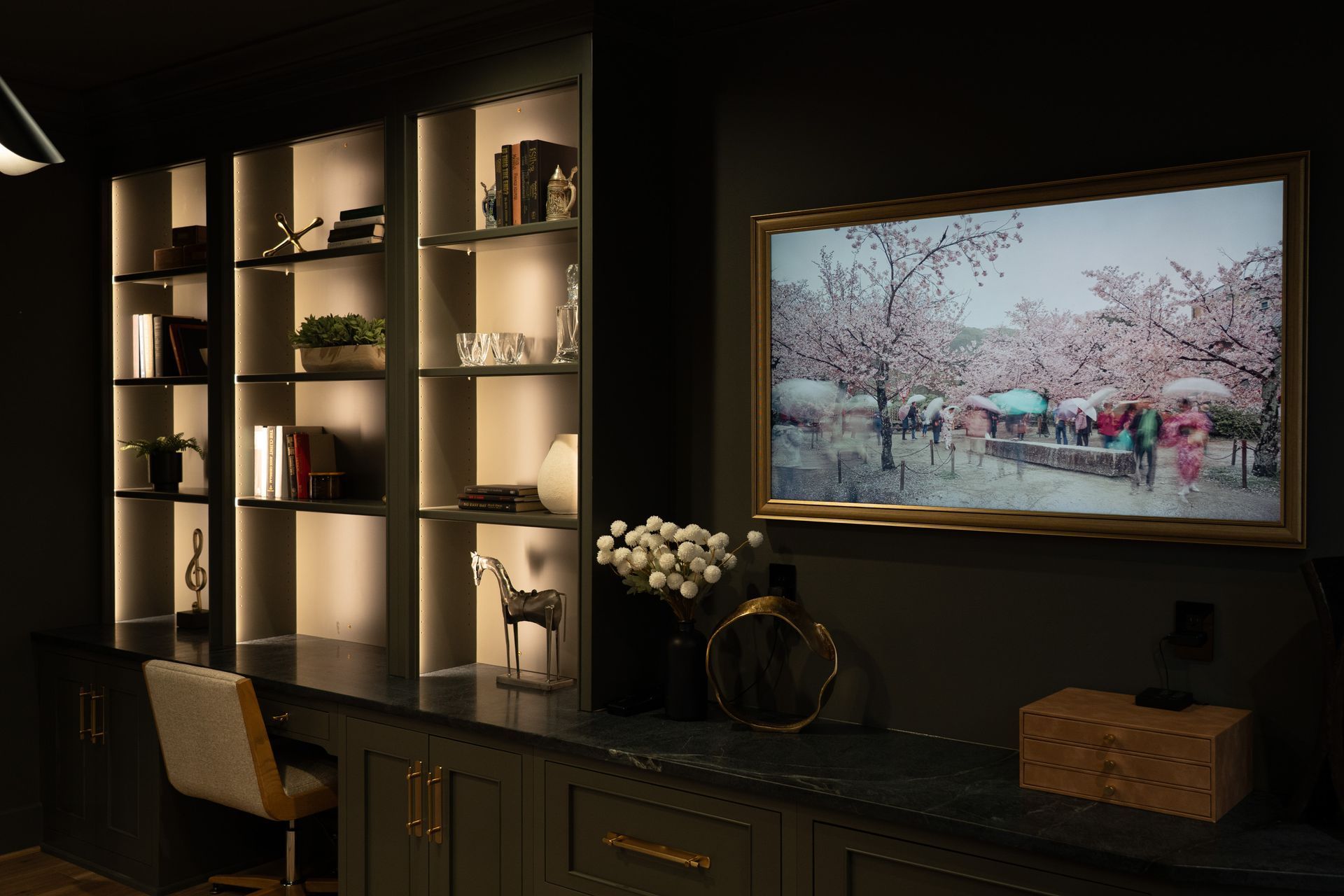 A living room with a large flat screen tv on the wall.