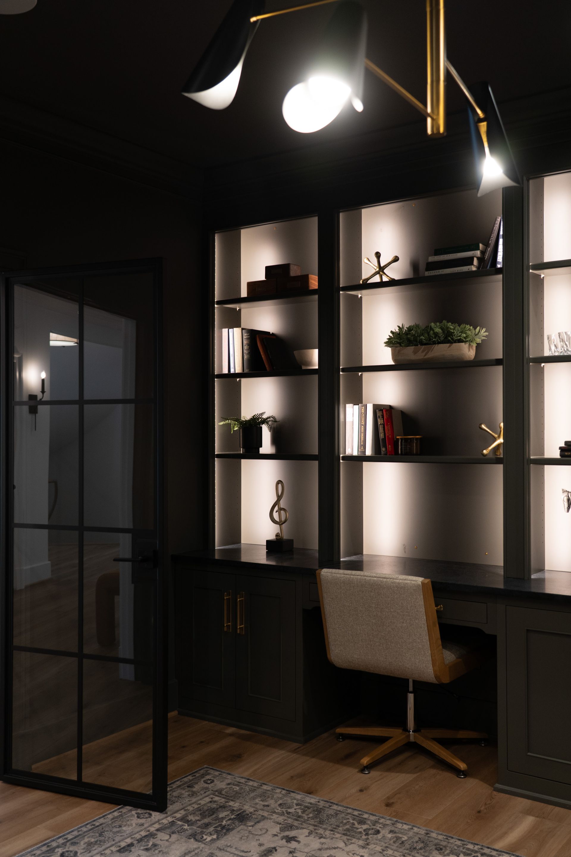 A room with a desk and a chair in it