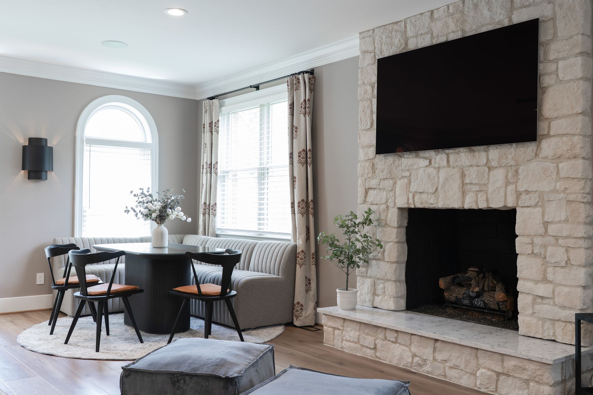 A living room with a fireplace and a flat screen tv.