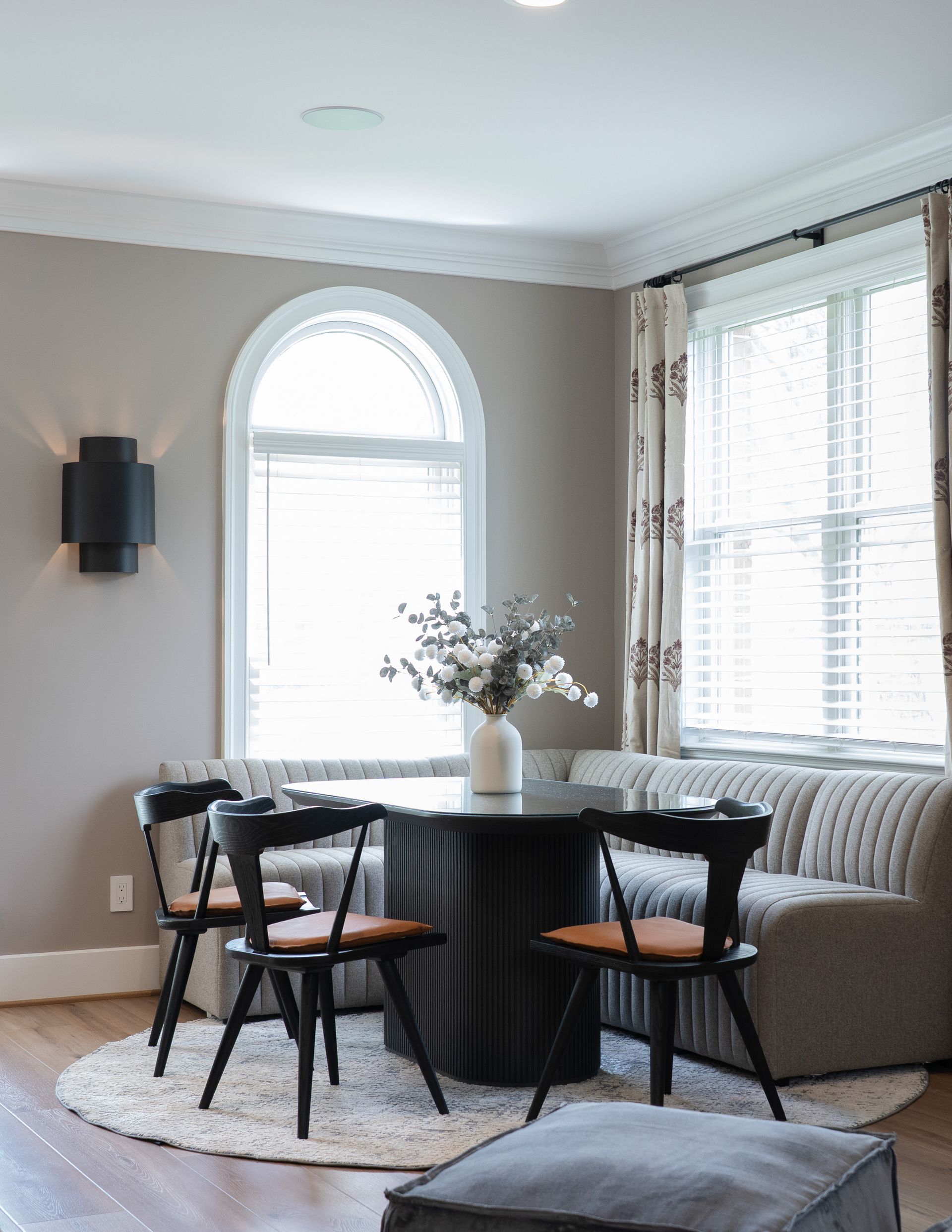 A living room with a table and chairs and a couch.