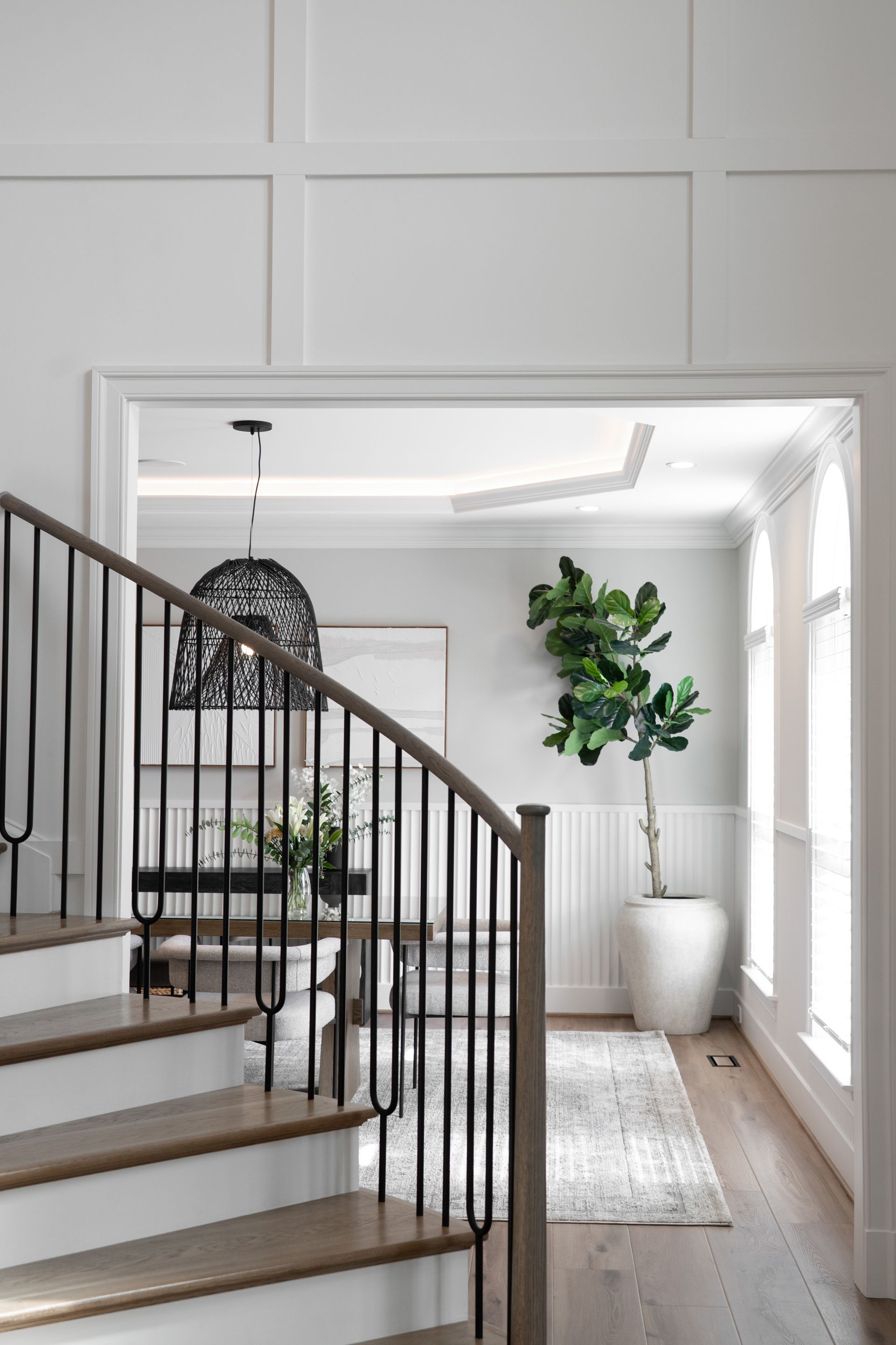 A staircase leading up to a living room in a house.