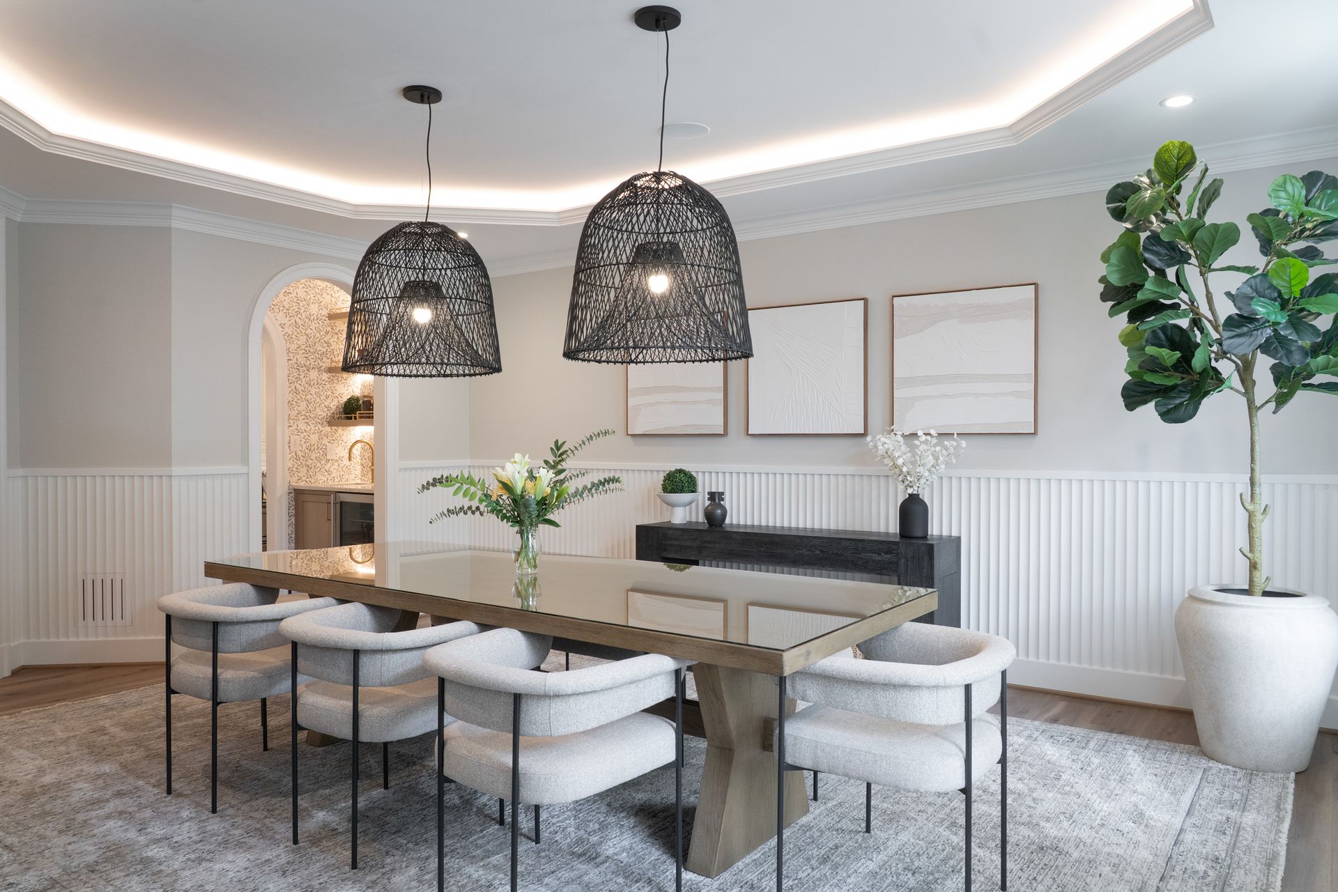 A dining room with a long table and chairs