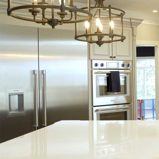 A kitchen with stainless steel appliances and a white counter top