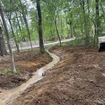There is a stream running through the woods.