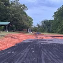 A large pile of dirt is sitting on top of a dirt road.