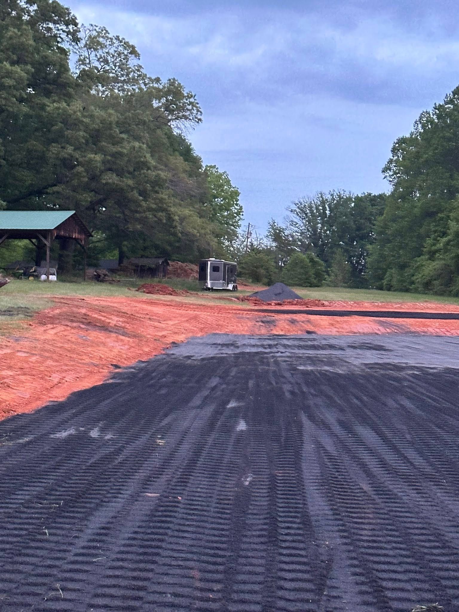 A large pile of dirt is sitting in the middle of a field.