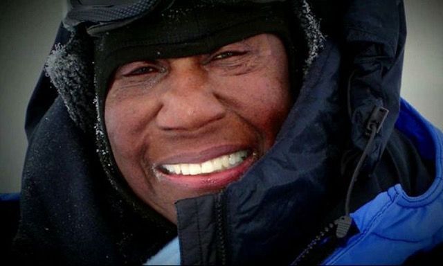 Person bundled in winter coat, smiling.