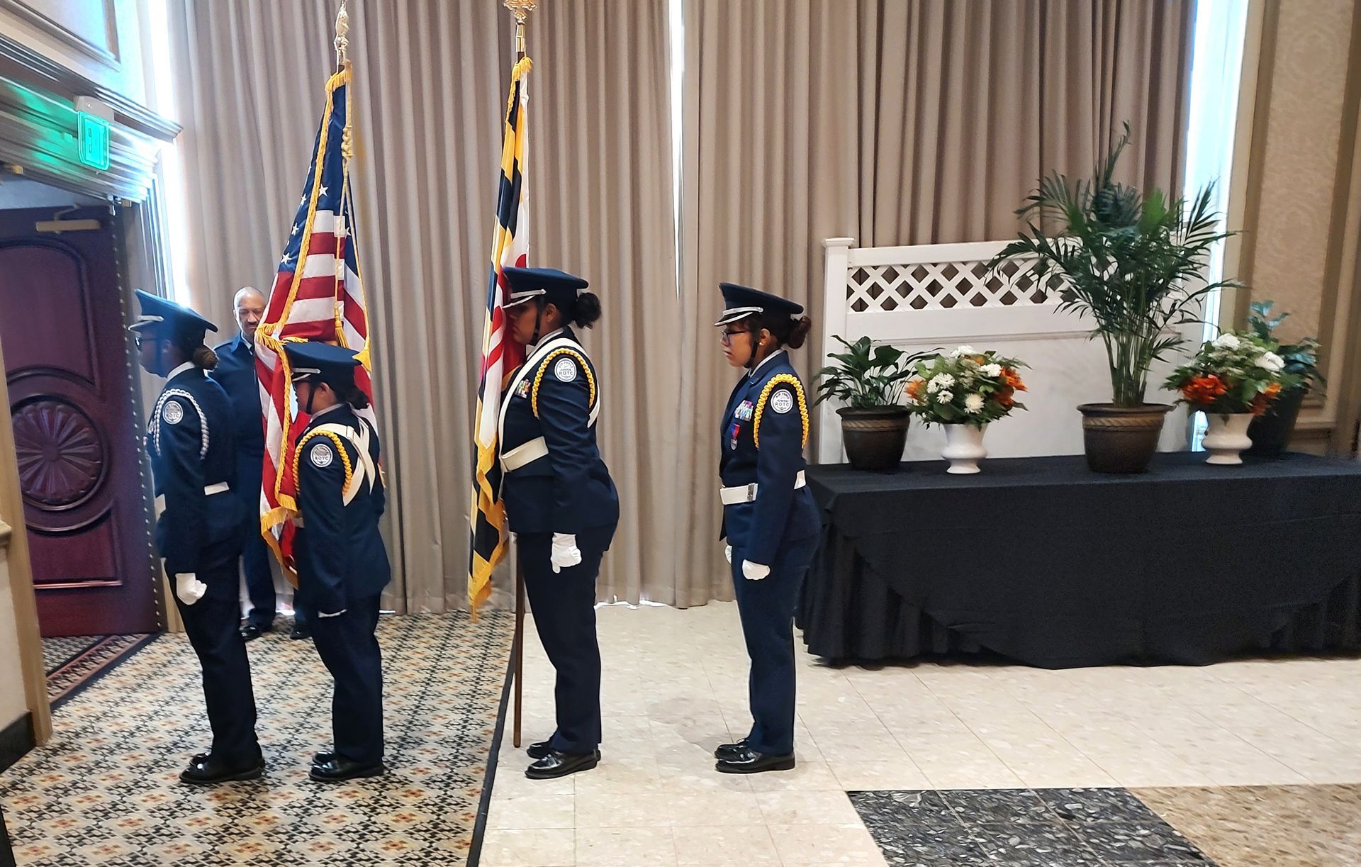 a group of people in military uniforms stand in front of flags