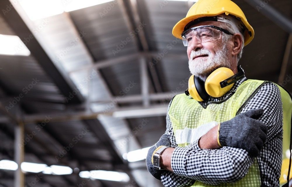 an older man wearing a hard hat and safety vest