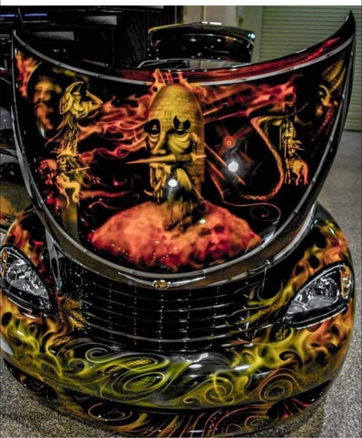A black car with yellow stripes on the hood